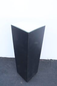 A square wood pedestal with bevel mirror top