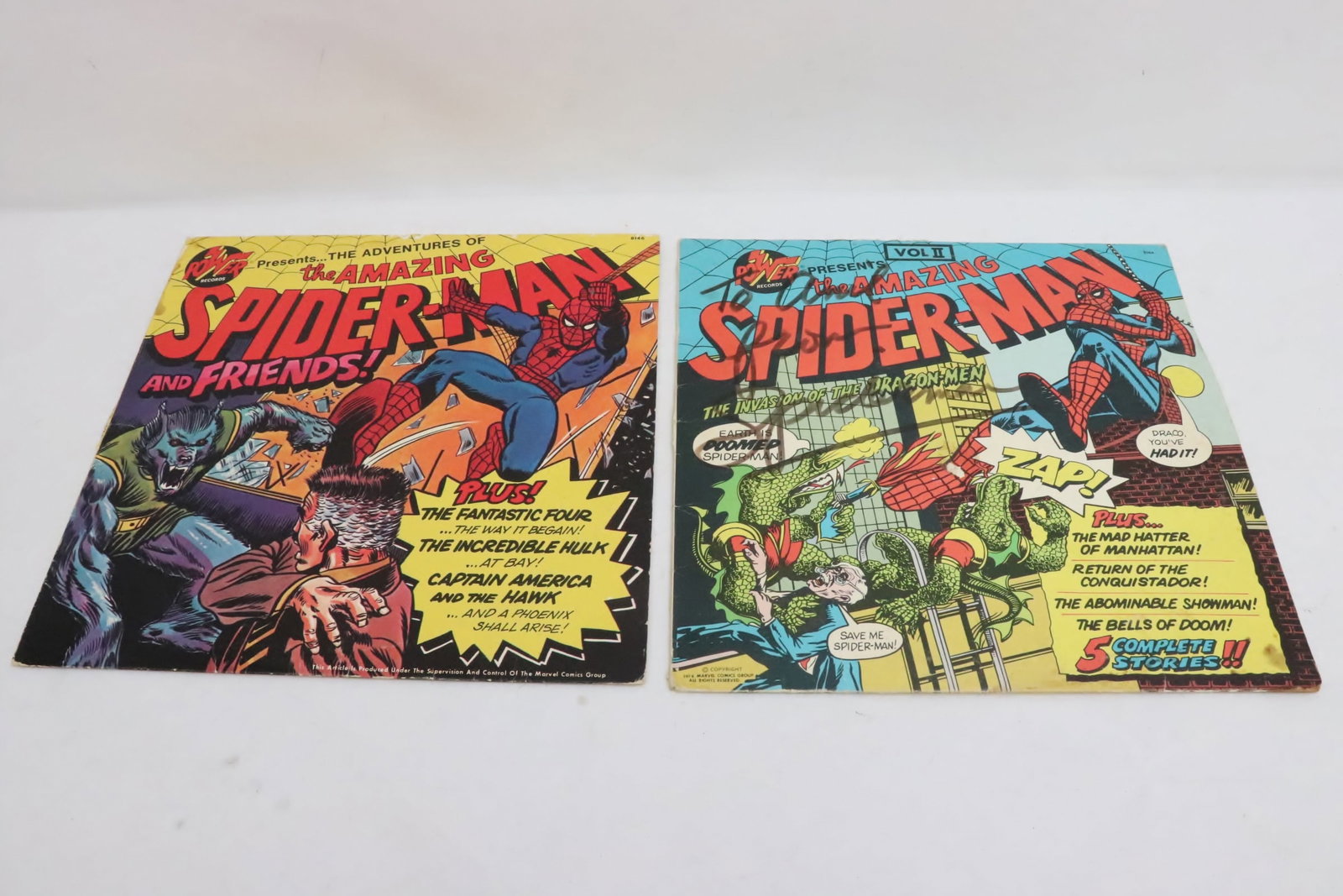 2 Spiderman signed 1975 LP: 2 LP; 1975 "the amazing spider man and friends", and 1975 "the amazing spider man, the invasion of the dragonmen", both signed "spiderman", both has minor scratch