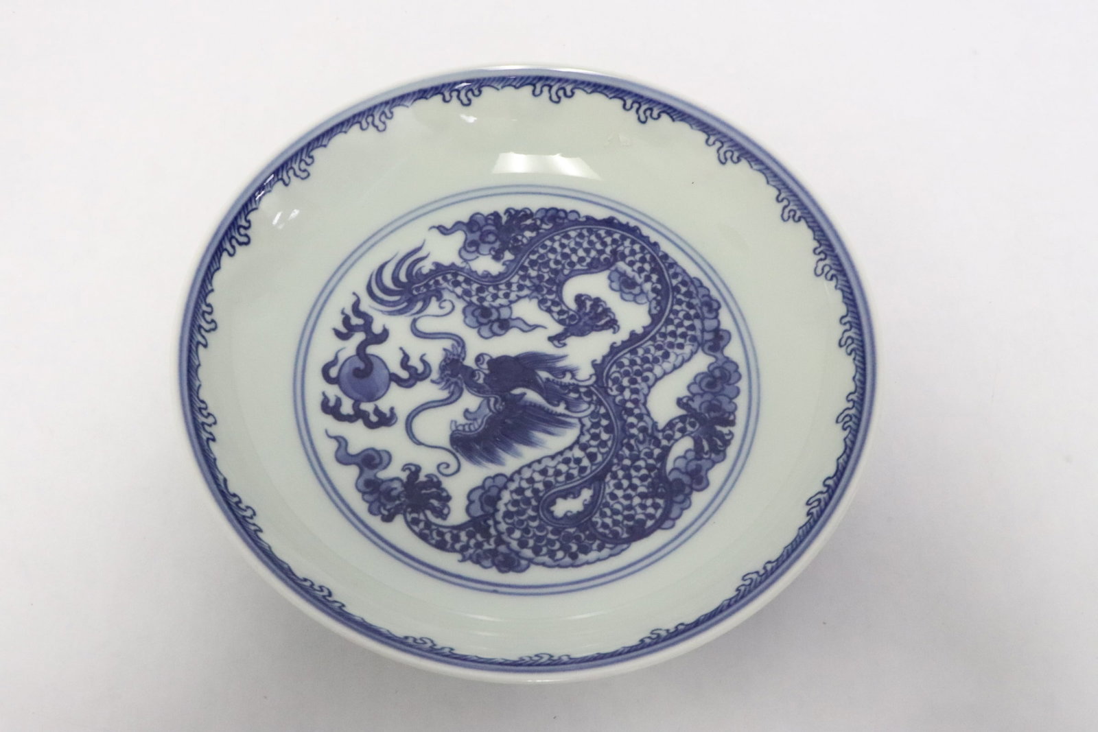 Blue and white small porcelain plate: Blue and white small porcelain plate with dragon motif decoration, 1.55"x6.25"dia