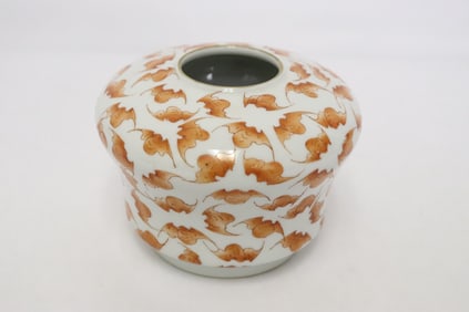 A red and white porcelain water dripper