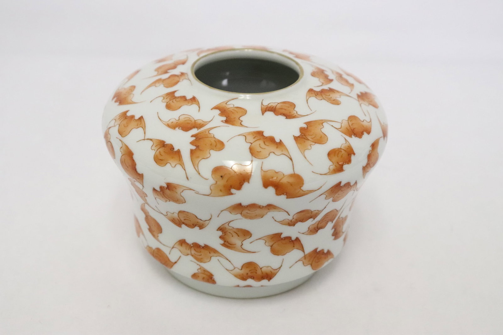 A red and white porcelain water dripper: A red and white porcelain water dripper, 3.2"x4.15"dia