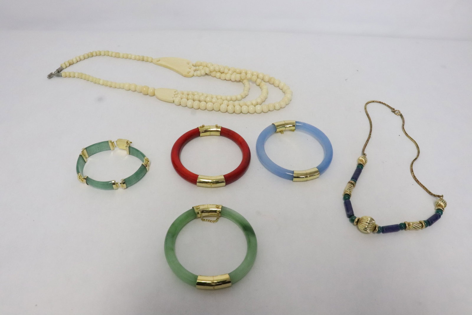 5 pieces: 5 pieces; a necklace (21.5"L) with bone carved ornament and beads, 3 Peking glass hinged bangles (0.33"x2.8"dia - 0.33"x2.85"dia), a bracelet (7.25"L) with jadeite like plaque, and a gold filled neckl