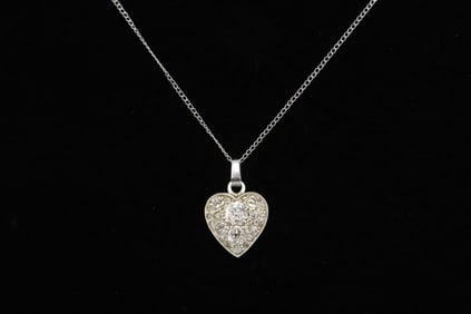 A platinum diamond pendant w/ 14K necklace