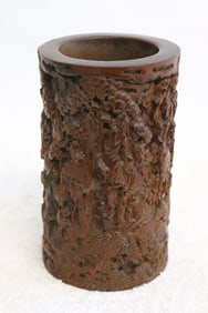 A small wood carved brush holder