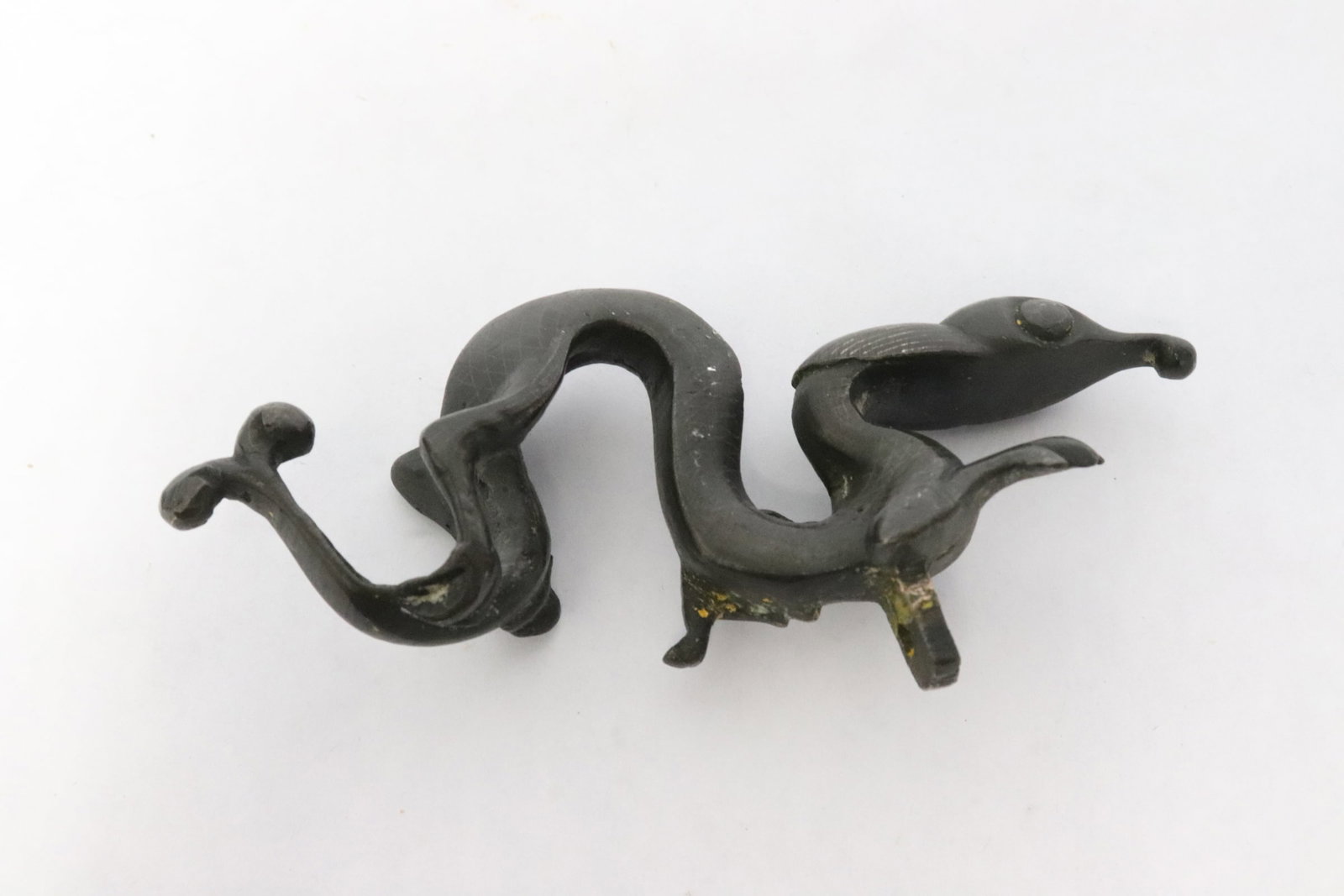 A possible silver inlaid antique bronze ornament: A possible silver inlaid antique bronze ornament in the form of qilin(?), a sword/ furniture attachment(?), 4.35"L