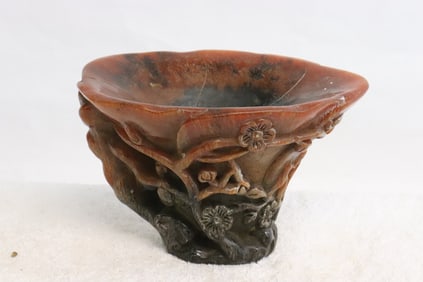 A simulated horn carved libation cup