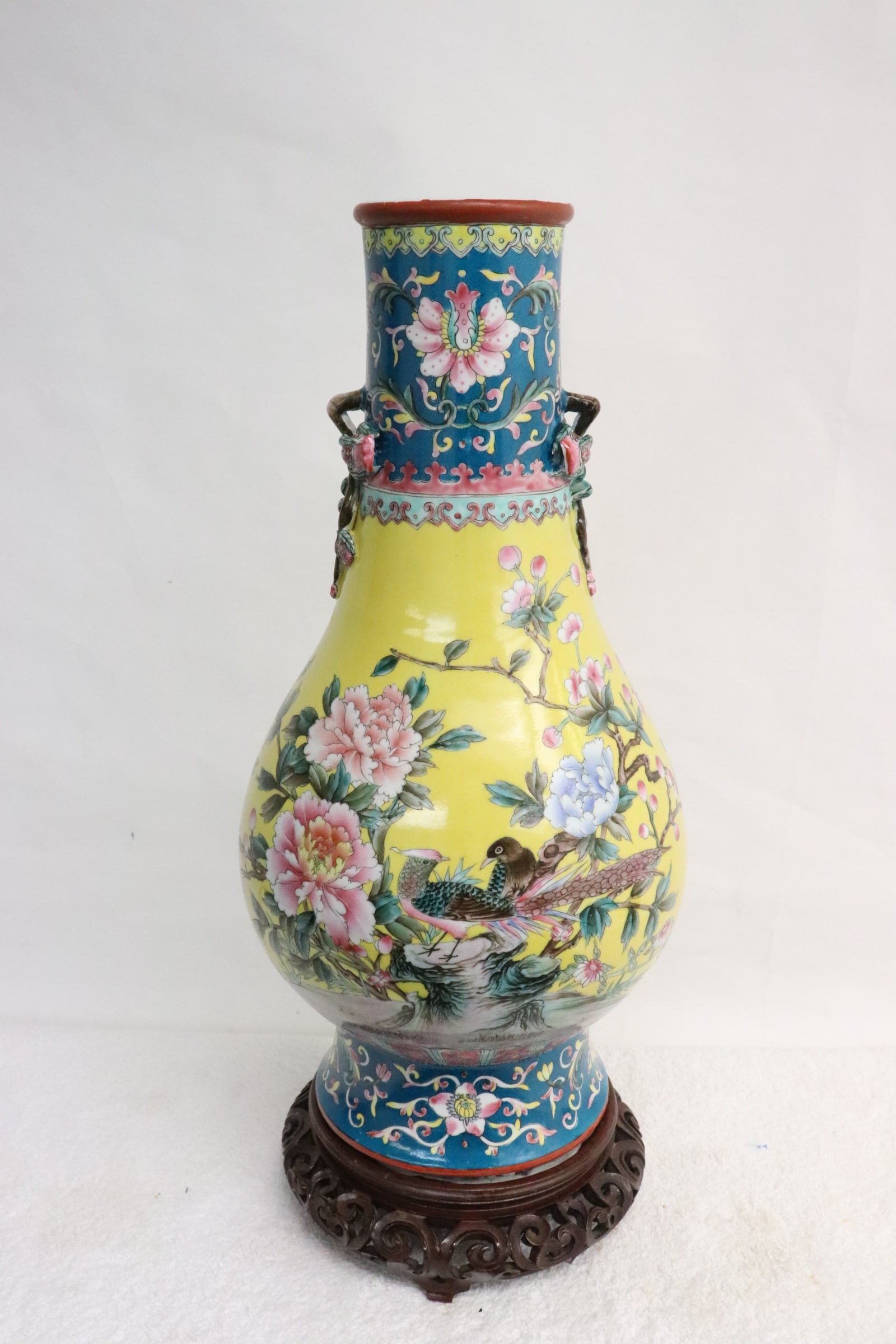 Chinese famille rose porcelain vase on stand: A beautiful Chinese famille rose porcelain vase (16.25"x8"dia) with handles in the motif of fruit branch, on stand