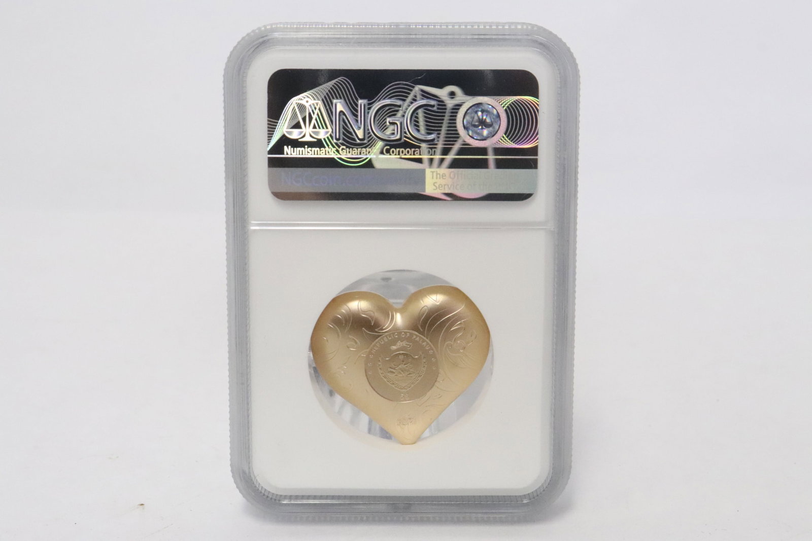 An NGC MS 70 Palas $5 1 troy ounce gilt silver rosy heart: An NGC MS 70 Palas $5 1 troy ounce gilt silver rosy heart, 0.25"x1.1"x1.25"