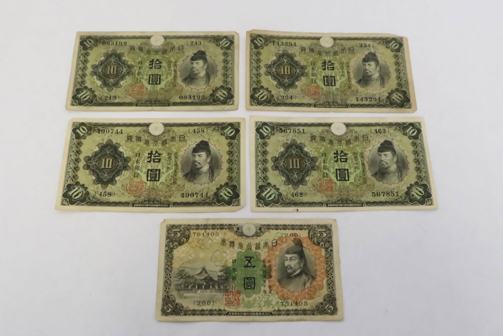 5 Japanese banknotes: 5 Japanese banknotes; four 10-dollar, and one 5-dollar