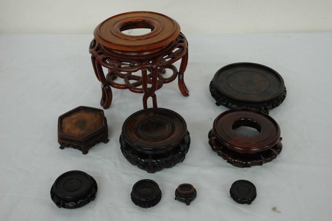 Chinese stands, incl. antique snuff bottle stand: Lot of Chinese wood carved stands (6.2"x7.9"dia, 1.6"x6.3"dia, 2.2"x5"dia, 1.9"x5.2"dia, 1.5"x4.2"x3.7", 1.1"x2.9"dia, 0.9"x2"dia, 0.8"x1.7"dia) including a rare antique snuff bottle stand with silver