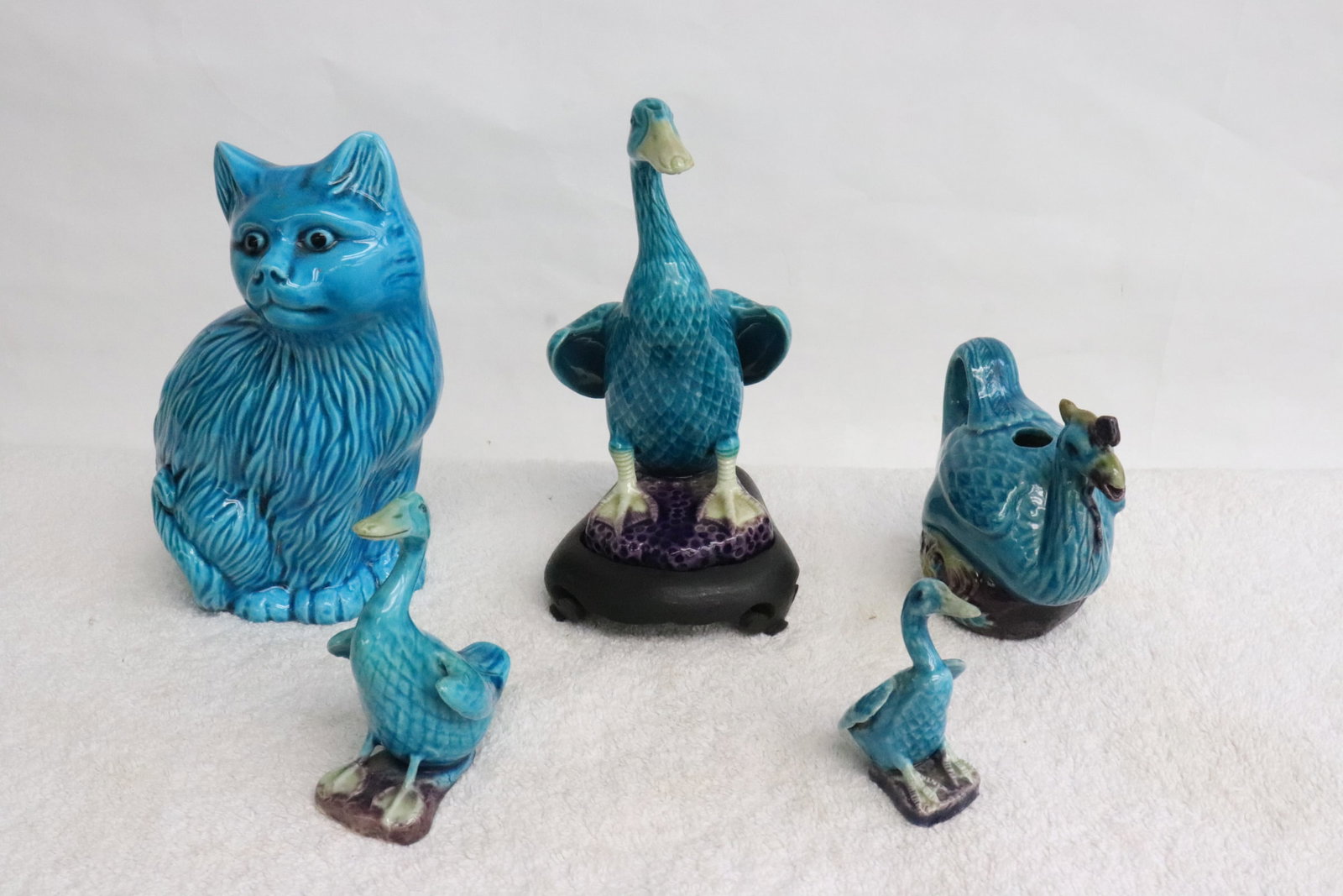 5 turquoise blue glazed pieces: 5 pieces; turquoise blue glazed ducks (2.7"H - 6"H), and a turquoise glazed cat (6.5"H)