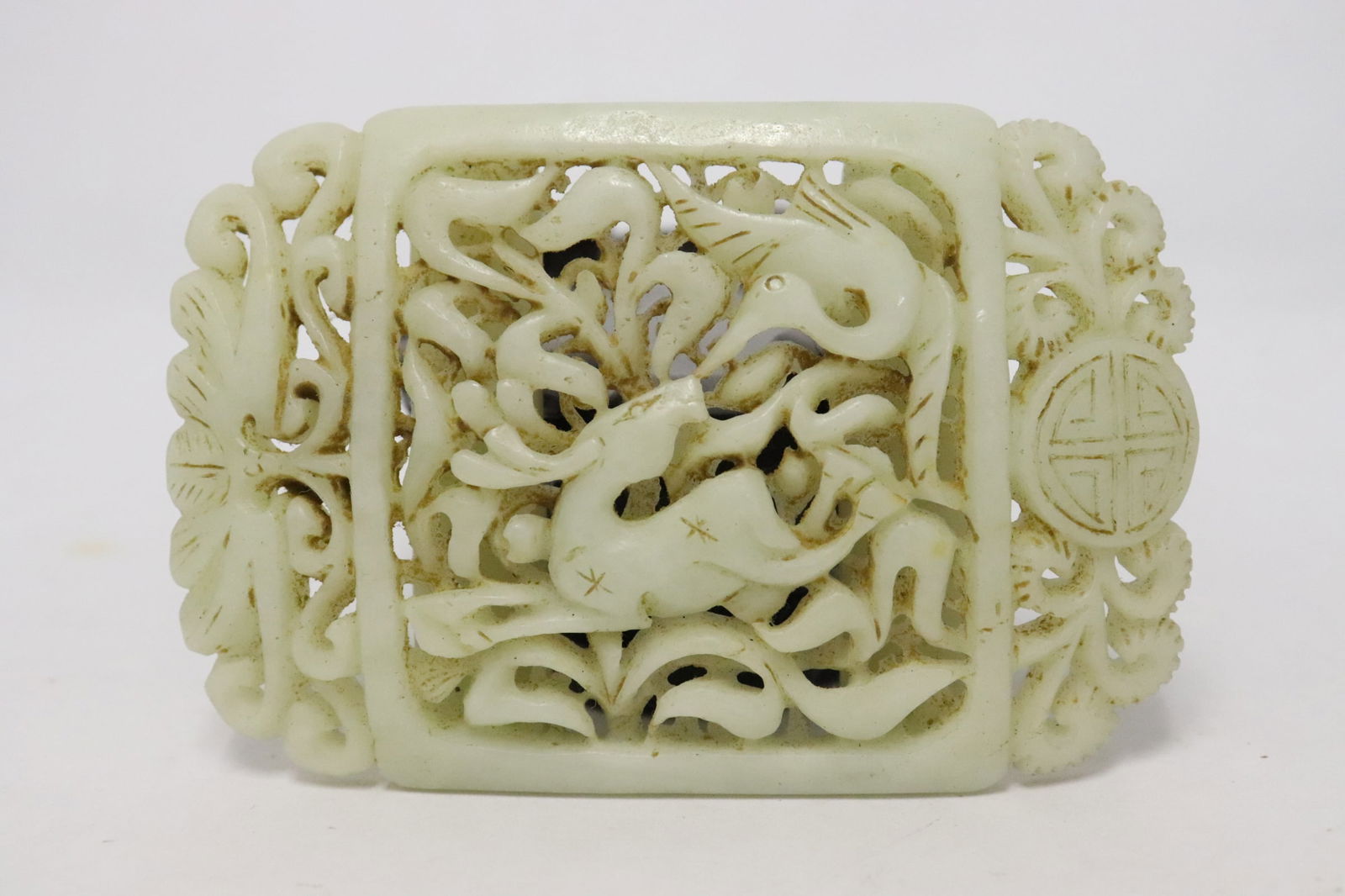A light celadon jade carved belt buckle: A light celadon jade carved belt buckle, 0.5"x2.35"x3.6"