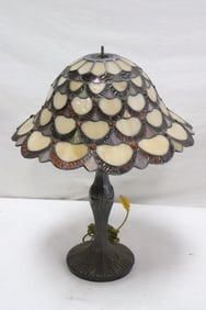 A metal based lamp with leaded glass shade