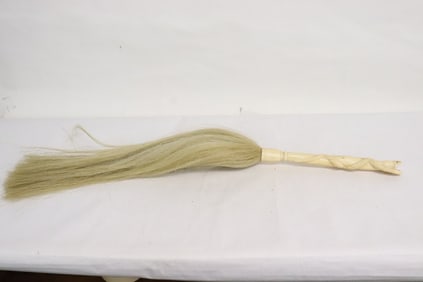 A horse hair brush with bone carved handle