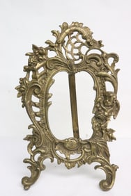 An ornate brass/ bronze tabletop picture frame