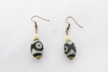 Pair earring, each set with a dzi bead