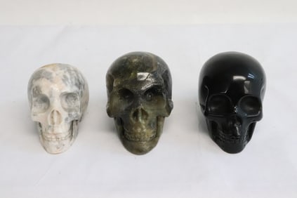 3 stone carved skulls