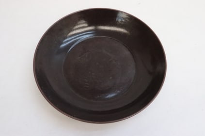 A brown glazed porcelain plate