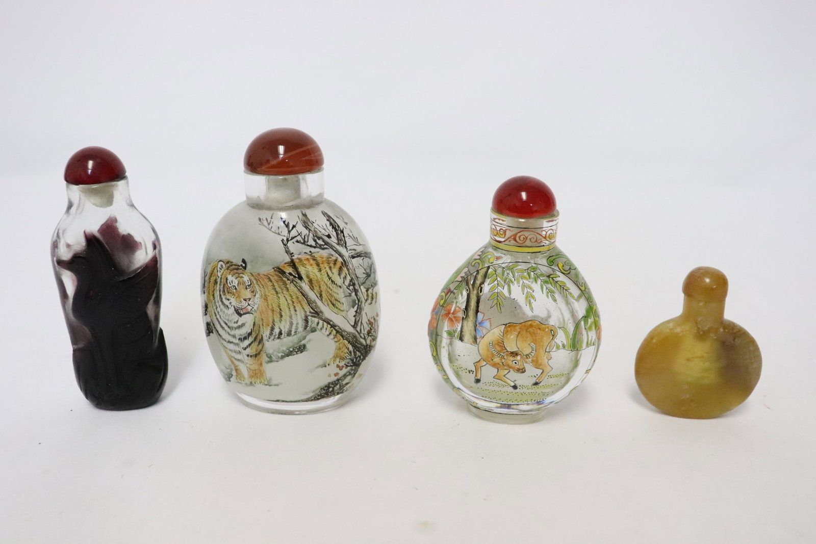 4 snuff bottles: 4 snuff bottles (1.9"x1.5"x0.35" - 3.35"x2.15"x1.3"); enamel on glass, overlay Peking glass, and stone carved