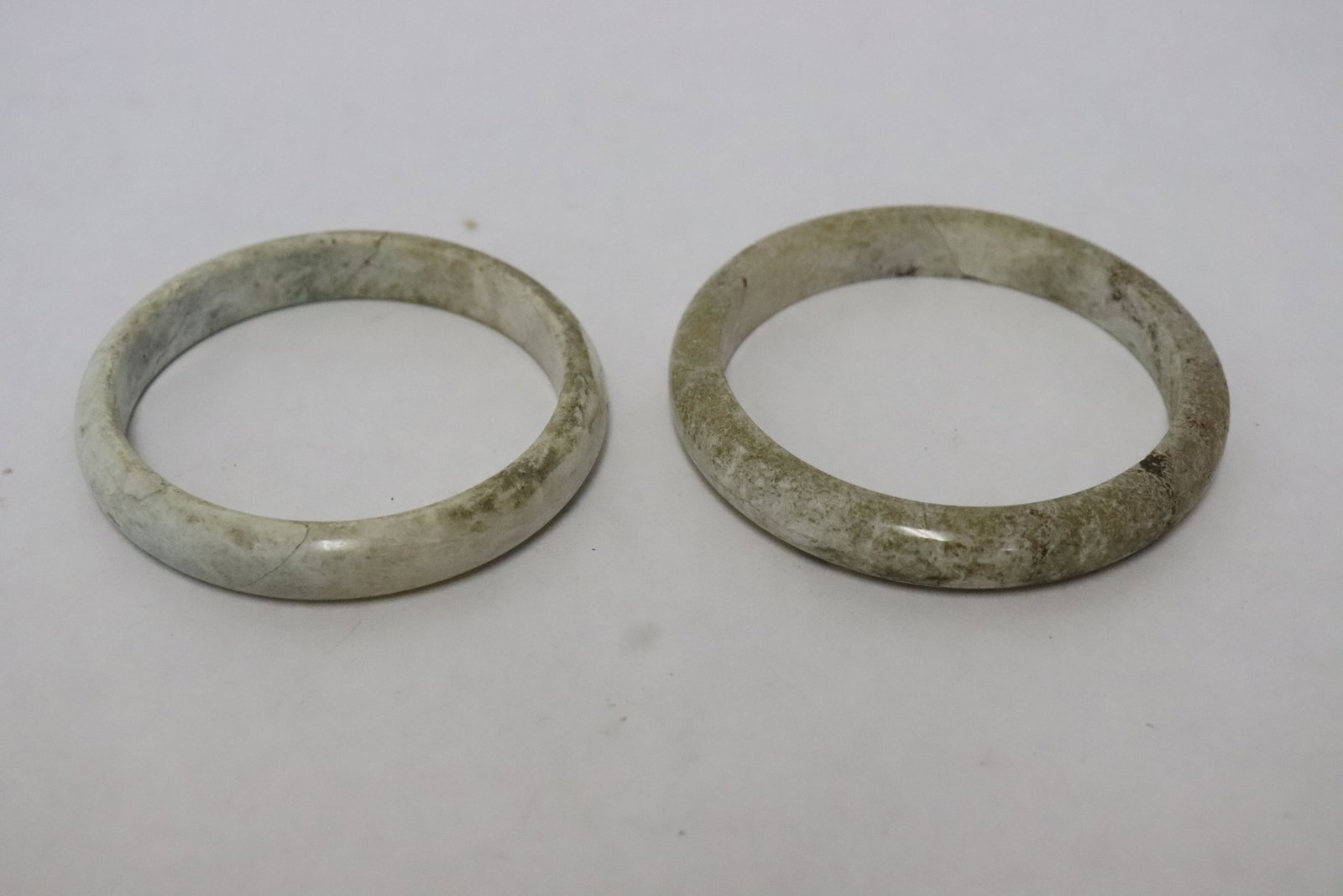 2 stone carved bangles: 2 stone carved bangles, 0.35"x2.7"dia, 0.38"x2.85"dia