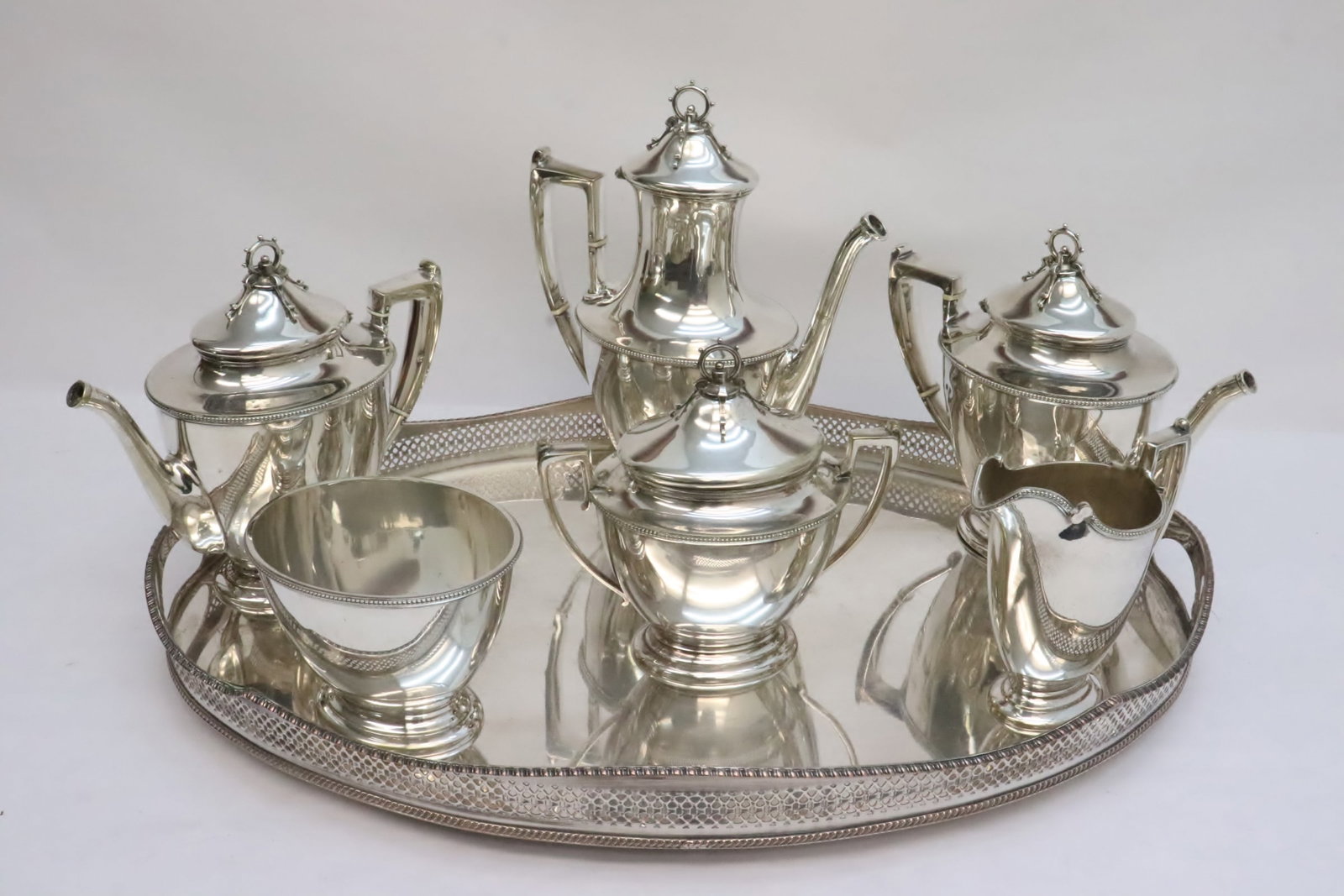 7 pieces early 20th c. silverplate tea and coffee set: 7 pieces early 20th century silverplate tea and coffee set; including coffee pot (11.2"x9.3"x4.9"), 2 teapots (8.5"x9.45"x4.85", 8.6"x9.6"x4.95"), creamer (5.9"x5.8"x3.18"), sugar (4.3"x5.65"x4.7"), a
