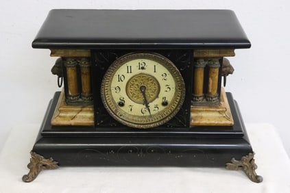 A wood carved table clock by Gilbert Clock co.
