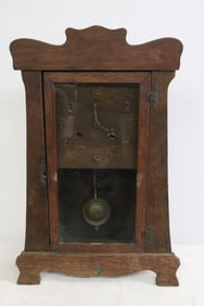 A rare arts and crafts oak cased table clock
