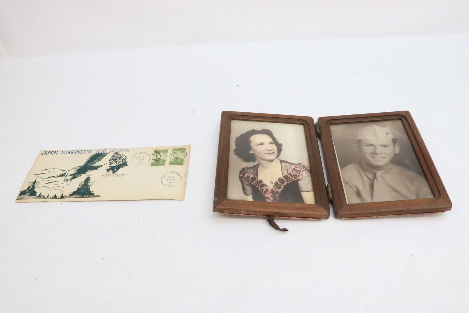 2 pieces: 2 pieces; a framed photo (7.9"x12"x0.65"), and an Aug. 14th, 1945 returned envelop