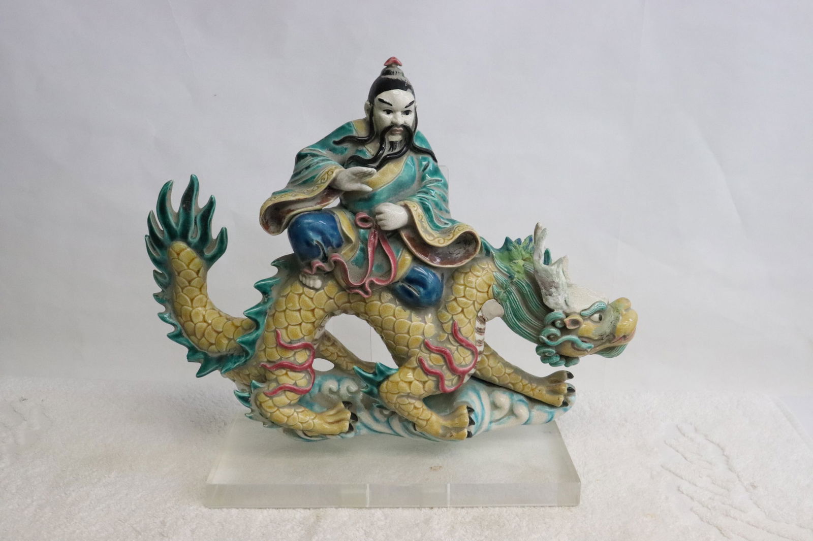 Chinese vintage roof tile mounted on Lucite stand: Chinese vintage roof tile (10.85"H) mounted on Lucite stand, depicting deity riding on dragon