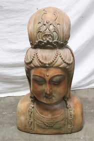 A massive terracotta sculpture of Buddha head