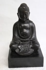 bronze sculpture of seated Buddha on wood stand