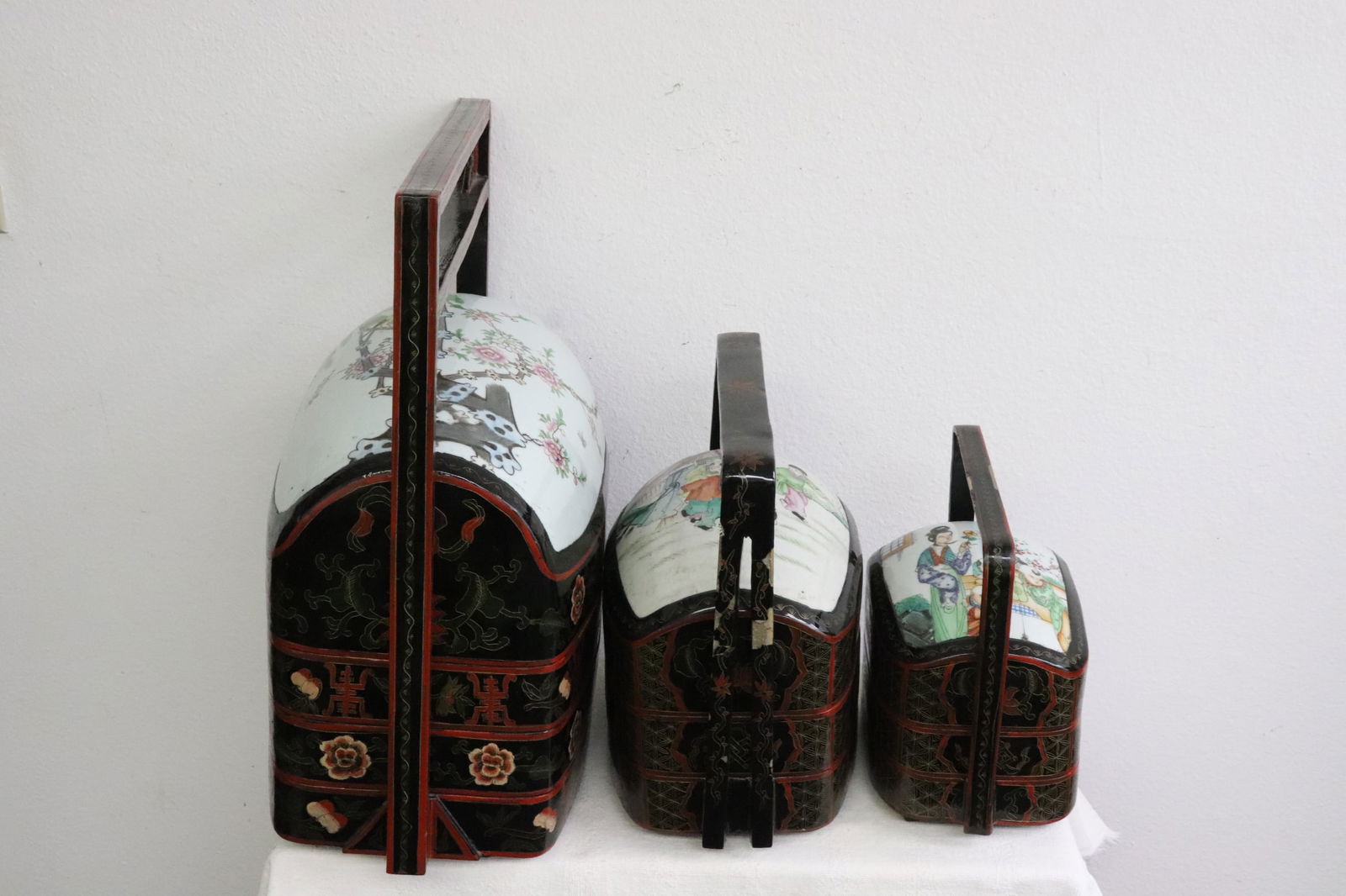 3 Chinese lacquer handled stacked box sets: 3 Chinese lacquer handled stacked box sets, cover decorated with Chinese antique porcelain dome, 9.6"x9.95"x6.2" - 18.85"x17.35"x9.7"