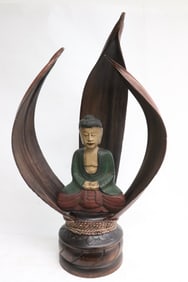painted wood sculpture of Buddha enclosed in open shrine