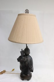 A metal sculpture of figure, made as lamp