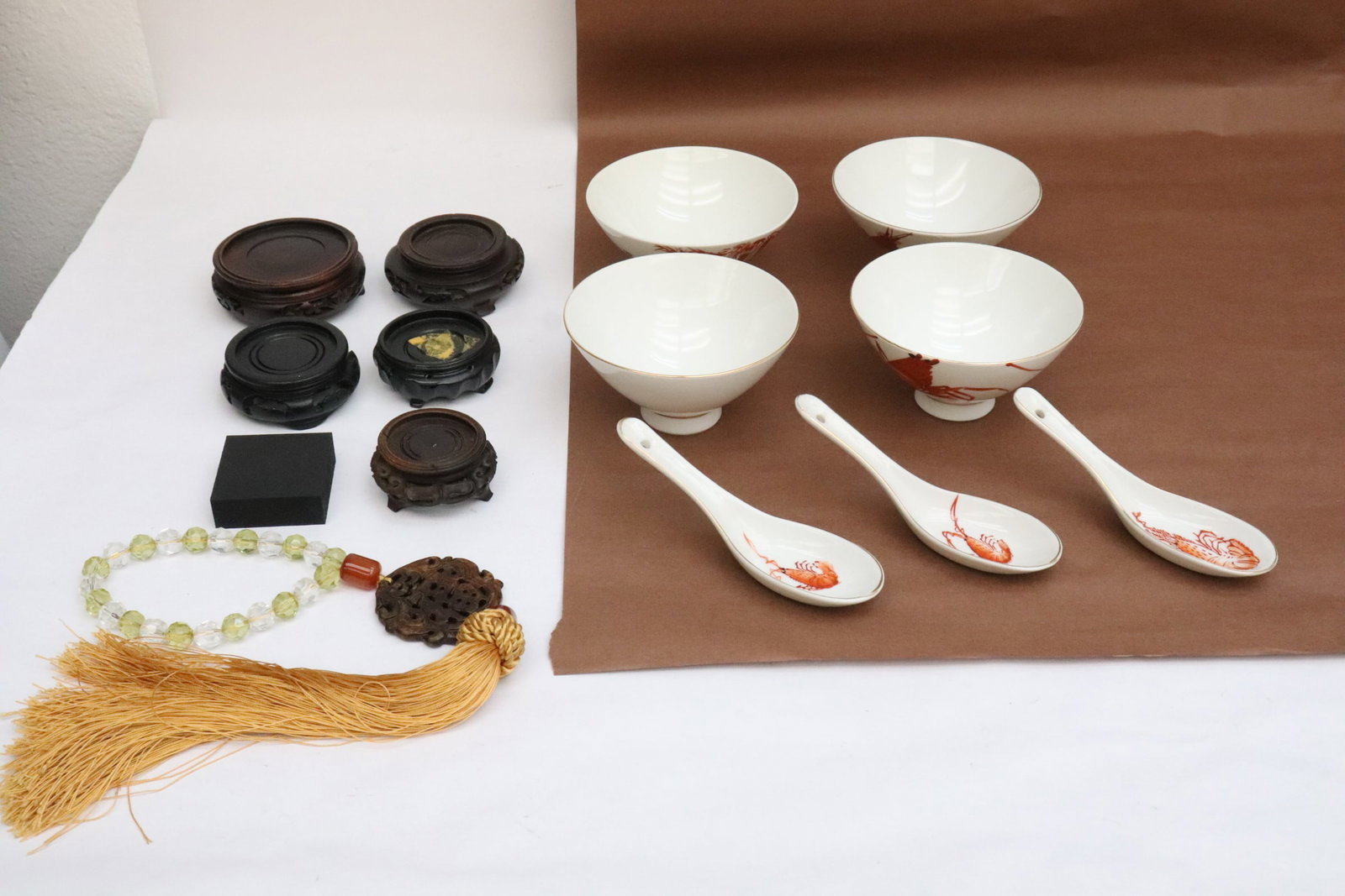 Lot of misc.: Lot of misc.; porcelain bowls (2.35"x4.5"dia - 2.15"x4.65"dia), spoons (5.65"L ea), wood stands (0.65"x1.98"x1.98" - 1.25"x3.3"dia), and a jade carved ornament (0.2"x2.3"dia) with attached crystal bra
