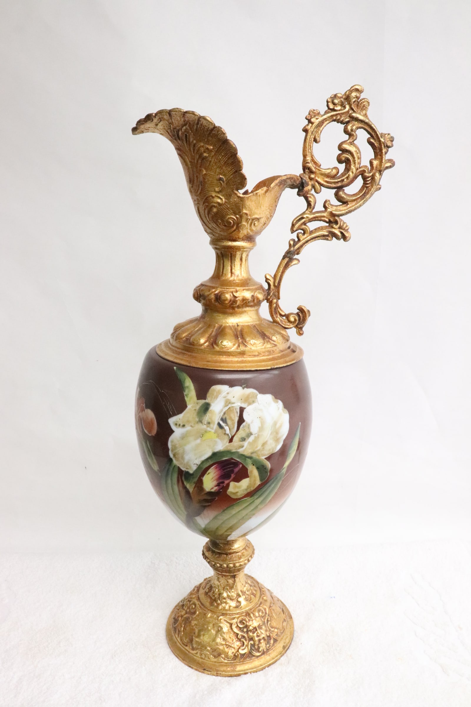 A painted and gilt European ewer: A painted and gilt European ewer painted with flower, 22.8"x10.3"x6.9"