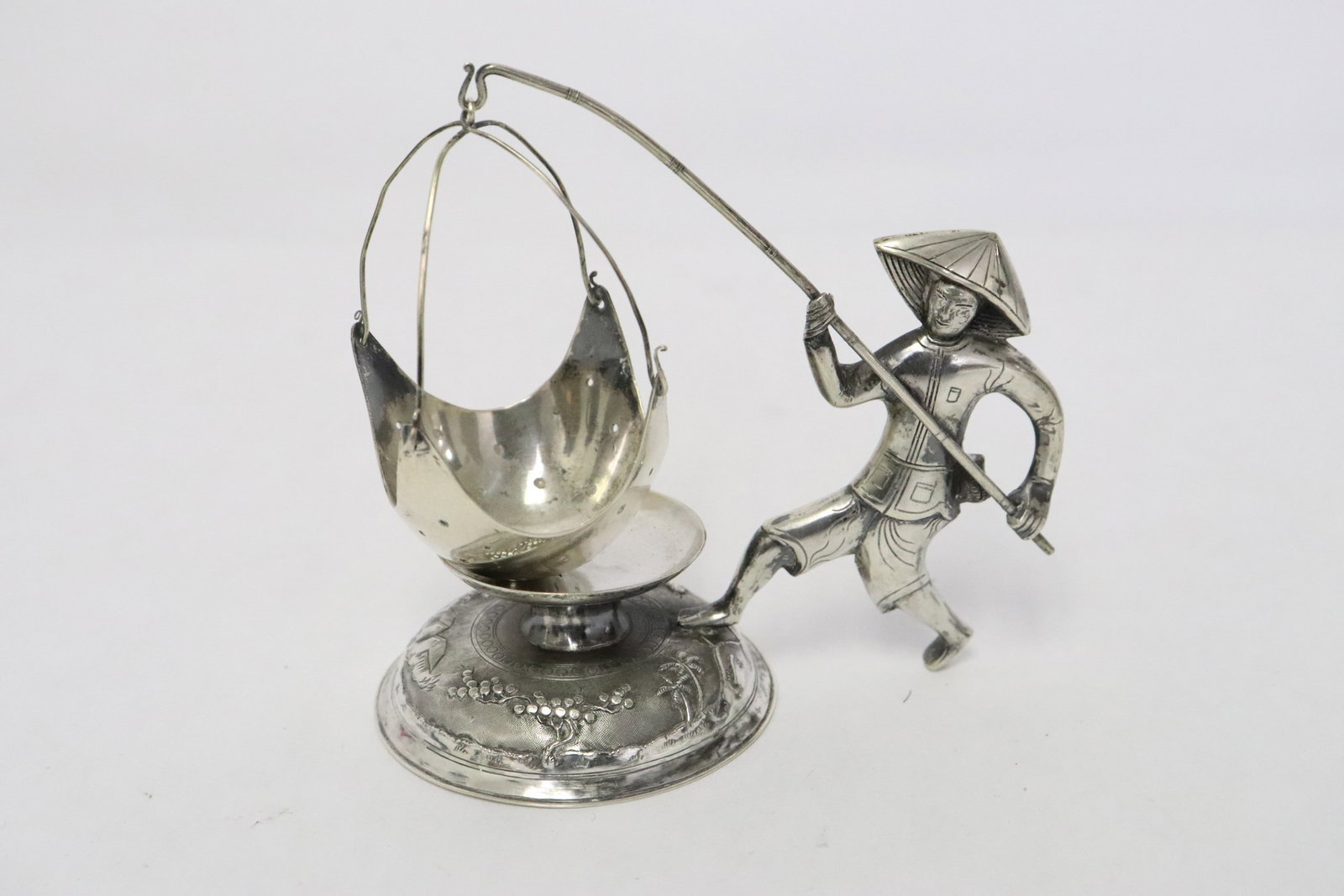 Vietnamese 900 silver ornament: Fine Vietnamese 900 silver ornament depicting fisherman with fishing net, wt. 58gm, 3.5"H
