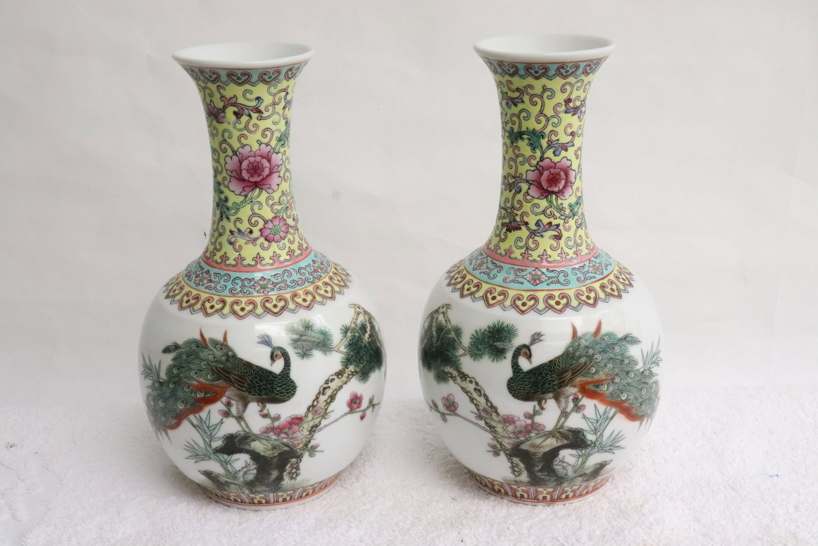 Pair Chinese vintage porcelain bottle vases: Pair Chinese vintage famille rose porcelain bottle vases decorated with peacock resting on pine tree, 9.4"x5.35"dia ea
