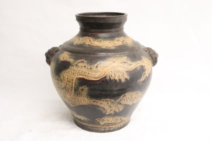 A brown glazed earthenware jar