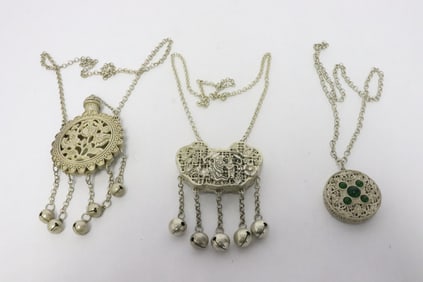 3 white metal scent boxes attached to necklaces