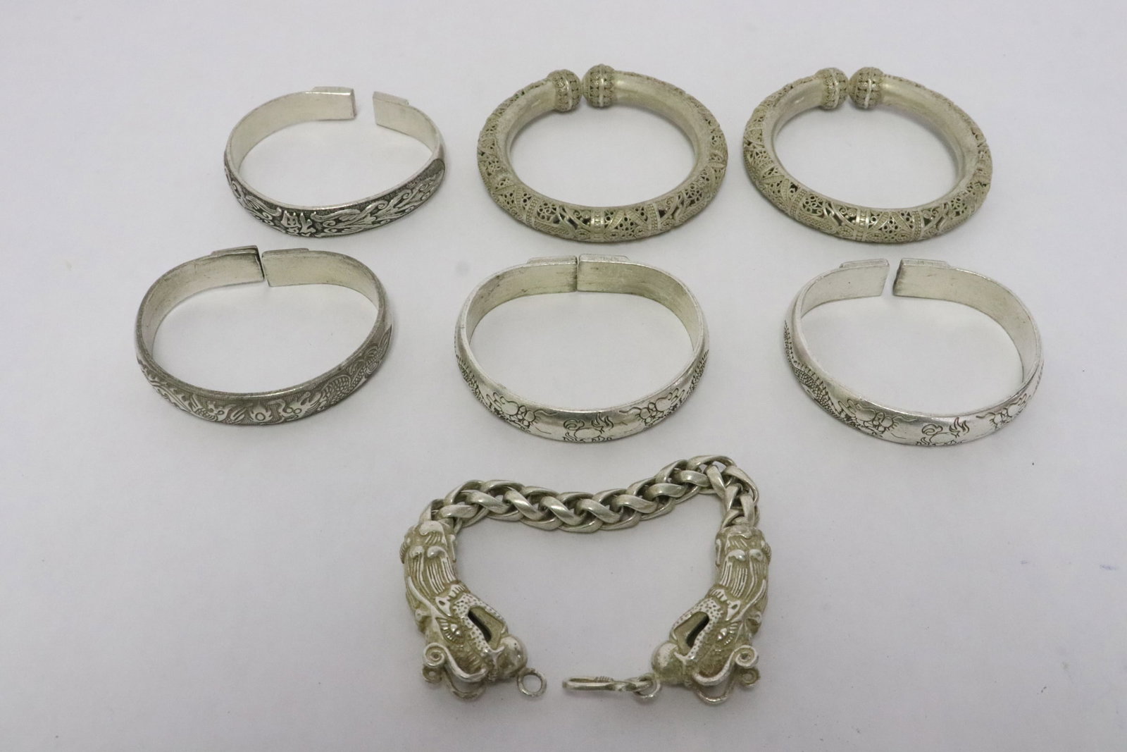 7 white metal bracelets/ bangles: 7 white metal bracelets (7.8"L)/ bangles (0.5"x2.4"x2.9" - 0.45"x3.3"dia)