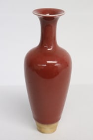 A red glazed porcelain slender vase