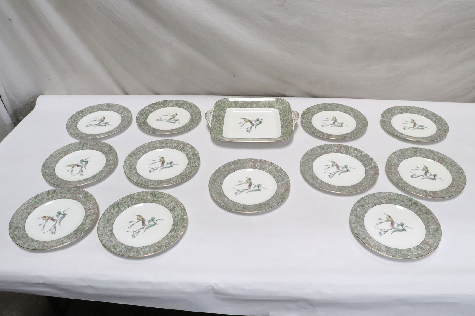 13 pieces Wedgwood china: 13 pieces Wedgwood china in humming birds pattern; including 12 plates (0.8"x8.15"dia ea) , and a serving platter (2"x11.15"x9.75")