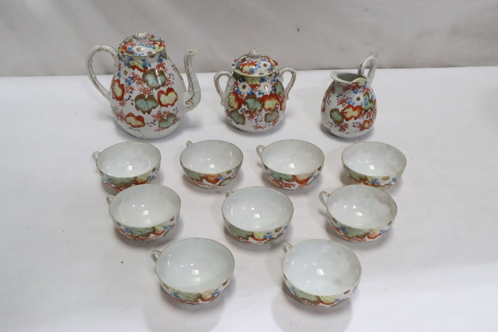 11 pieces vintage Japanese kutani tea service: 11 pieces vintage Japanese kutani tea service; including teapot (7.25"x7.8"x5.25"), creamer (5.15"x4.4"x3.8"), sugar (5.85"x5.7"x4.4"), and 8 tea cups (1.85"x4.6"x3.8" ea)
