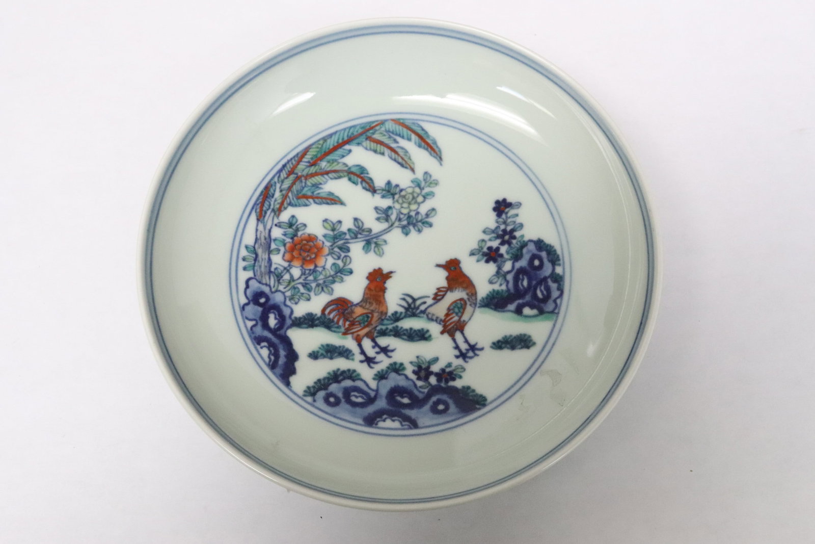 A small wucai porcelain plate: A small wucai porcelain plate with rooster in garden, 1.35"x6"dia