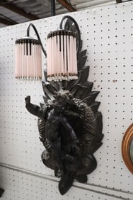 A resin wall sconce with carved angel