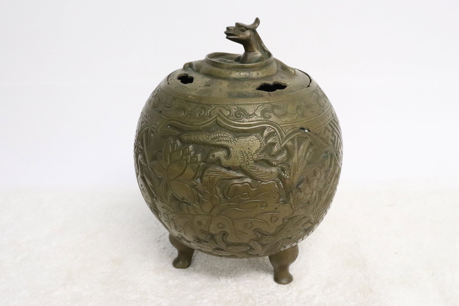 A bronze round covered censer: A bronze round covered censer with dragon motif finial, 7.85"x6.3"dia