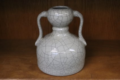 A light grey crackleware porcelain handled vase