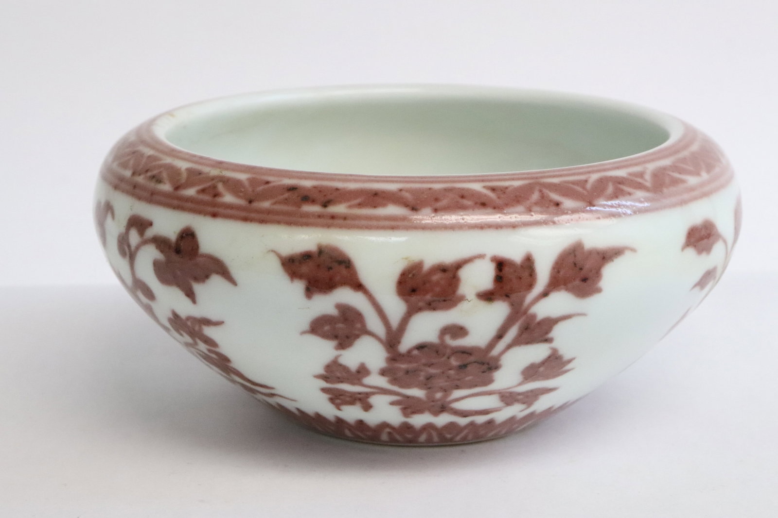 A red and white porcelain censer: A red and white porcelain censer with flower motif decoration, 2.85"x6.4"dia