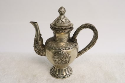 A white bronze wine pot with elephant motif spout